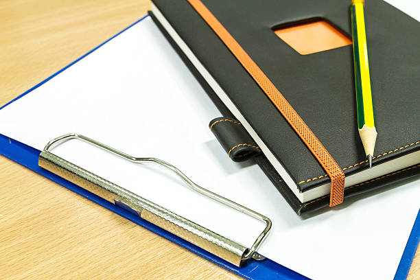 istock notebook and clipboard with blank paper on office table 494119481