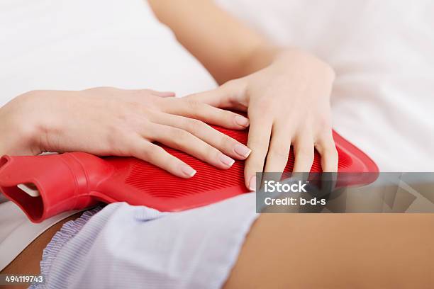 Beautiful Caucasian Woman Lying With Hot Water Bag Stock Photo - Download Image Now - Heat - Temperature, Abdomen, Stomach