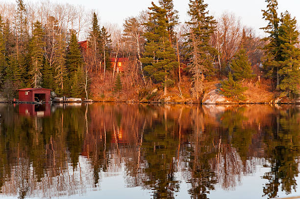 colorful reflects on a lake colorful reflects on a lake at twilight in Kenora, Ontario kenora stock pictures, royalty-free photos & images