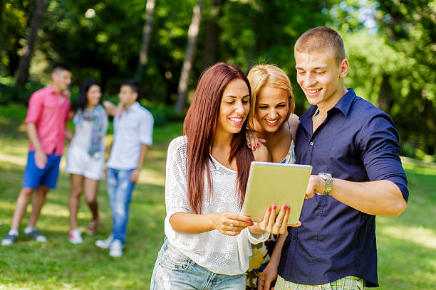 istock Teenagers with tablet in the park 494120043