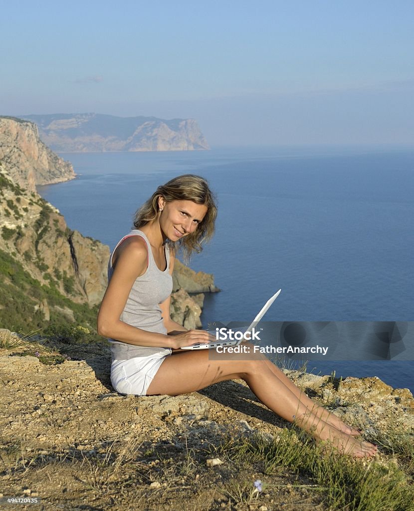 Beautiful girl with noteook on sea bay Adult Stock Photo
