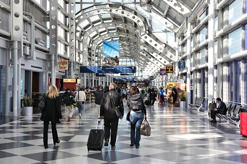Chicago, United States - April 1, 2014: Travelers walk to gates at Chicago O'Hare International Airport in USA. It was the 5th busiest airport in the world with 66,883,271 passengers in 2013.