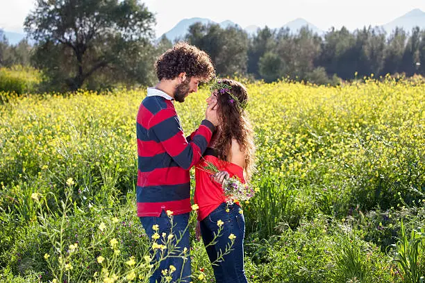 Photo of Loving young couple in a rapeseed field.