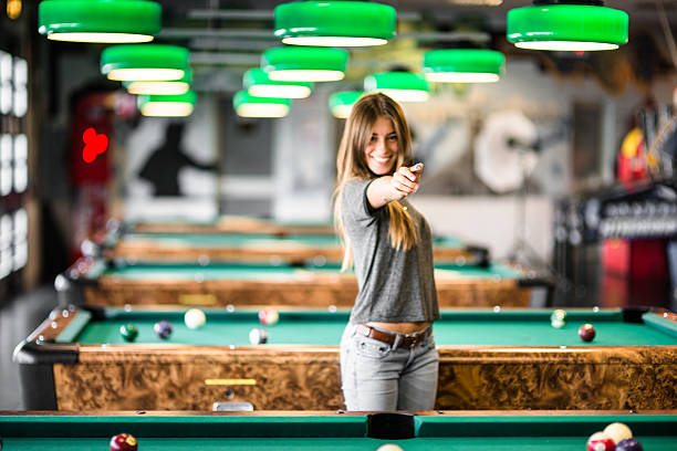 istock Happiness girl standing in a pub at the pool table 494121730