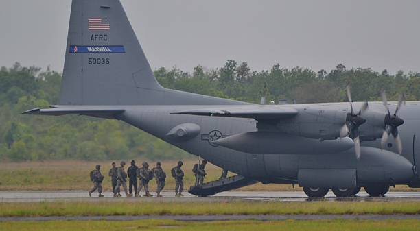 C-130 Airplane Deployment Florida, USA - May 10, 2014: American Army troops deploying on a C-130 Hercules. military deployment photos stock pictures, royalty-free photos & images