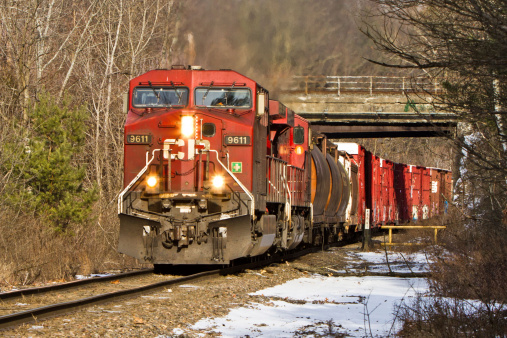 Rotterdam, New York, United States - February 5, 2013: Canadian Pacific freight train working upgrade out of Schenectady NY on a sunny winter day. This was the Delaware and Hudson main.