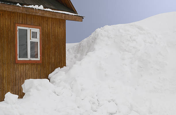 istock Wooden house and much snow. 494123692