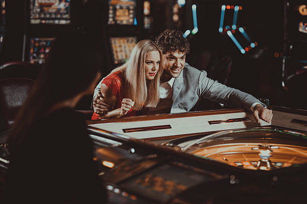Excited couple  gambling at electronic roulette in casino stock photo