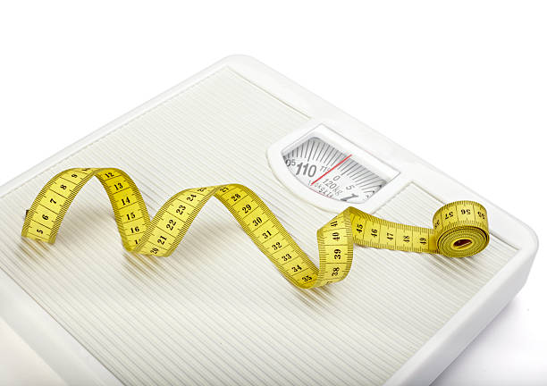 istock scale libra measurement tape diet fruit food apple 494123853