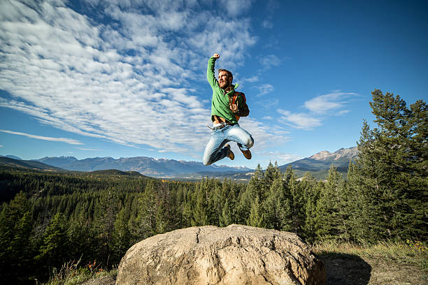 istock Young man jumping high up on a mountain top 494126508
