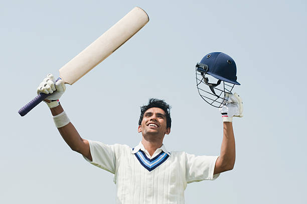 Cricket batsman celebrating his success Cricket batsman celebrating his success cricket player stock pictures, royalty-free photos & images