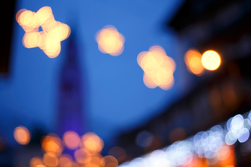 Christmas star bokeh backgrounds. Church Cortina Background - Defocused night lights multicolored. Cortina d'Ampezzo.