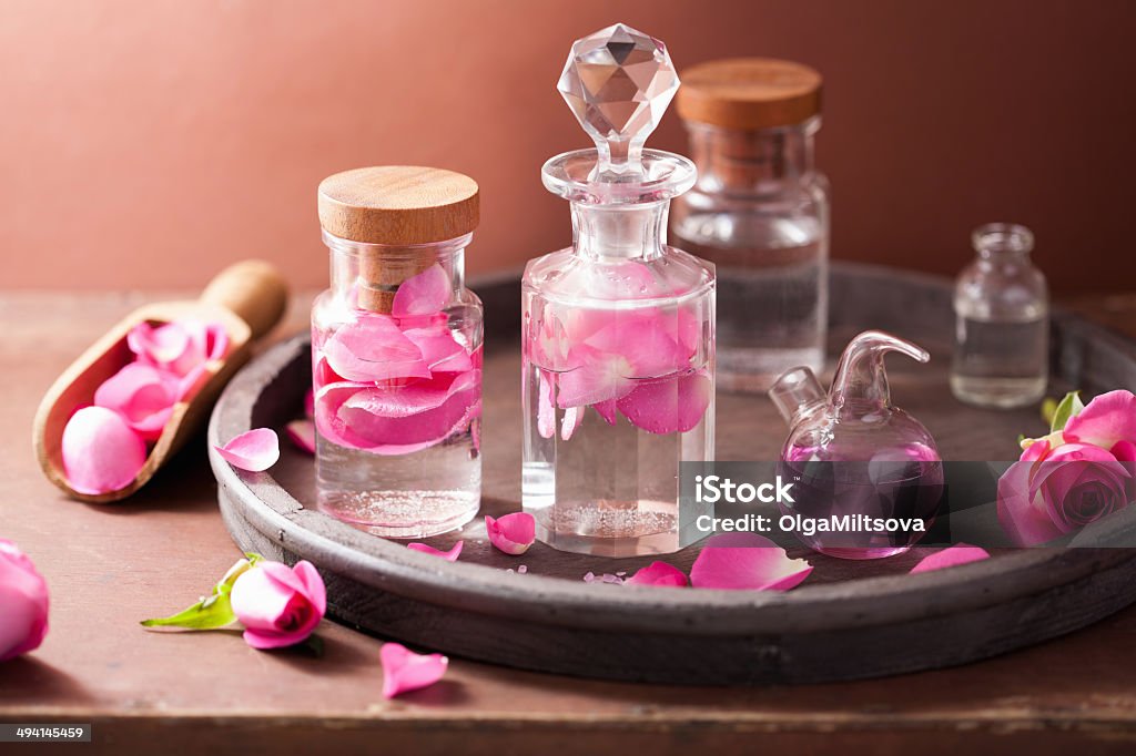 alchemy and aromatherapy set with rose flowers and flasks Alchemy Stock Photo