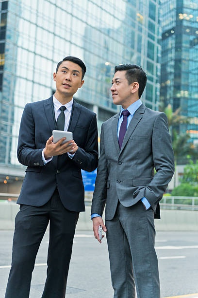 istock Two Businessmen with Mobile Device, Hong Kong, Asia 494146171