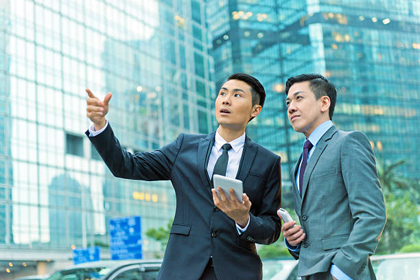 istock Two Businessmen with Mobile Device, Hong Kong, Asia 494146207