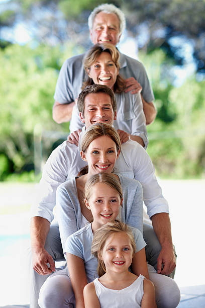 Portrait of a happy multi-generational family standing in a row outside