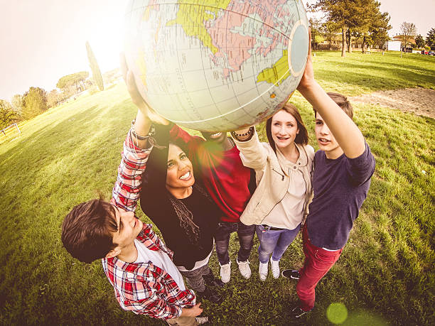 istock Group of teenagers holding an earth globe 494151407
