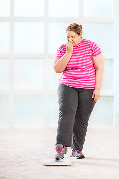 istock Overweight woman on a scale. 494151937