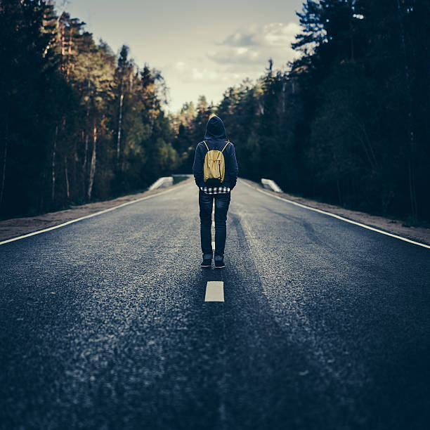 istock Traveler with backpack walking on the road 494152150