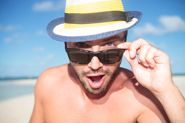 istock amazed young handsome man on the beach 494152173
