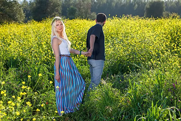 Photo of Beautiful young woman being led through a field.