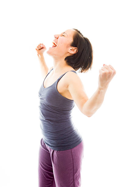 istock Young woman celebrating with her arms raised 494152343