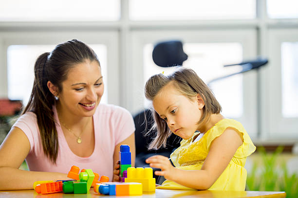 istock Mentally Handicap Child Playing with Building Blocks 494154772
