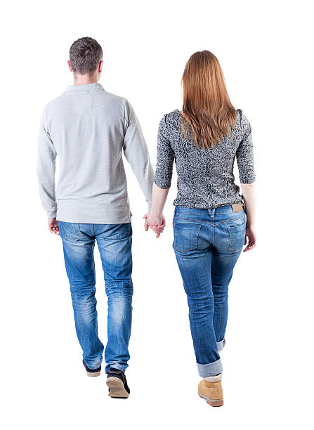 istock Back view going couple. walking friendly girl and guy holding 494155718