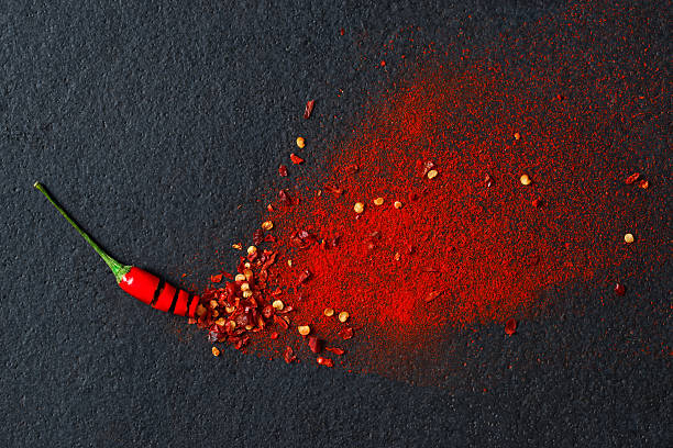 Chilli, Red Pepper Flakes and Chilli Powder Chilli, red pepper flakes and chilli powder burst chilli powder stock pictures, royalty-free photos & images