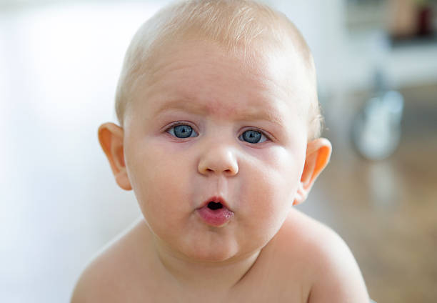 istock Cute smiling baby sitting at home. 494157312