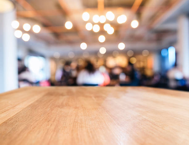 istock Table top with Blurred People Cafe Shop interior background 494157992
