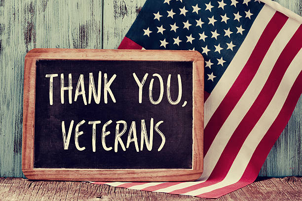 text thank you veterans in a chalkboard of the US the text thank you veterans written in a chalkboard and a flag of the United States, on a rustic wooden background thank you veterans day stock pictures, royalty-free photos & images