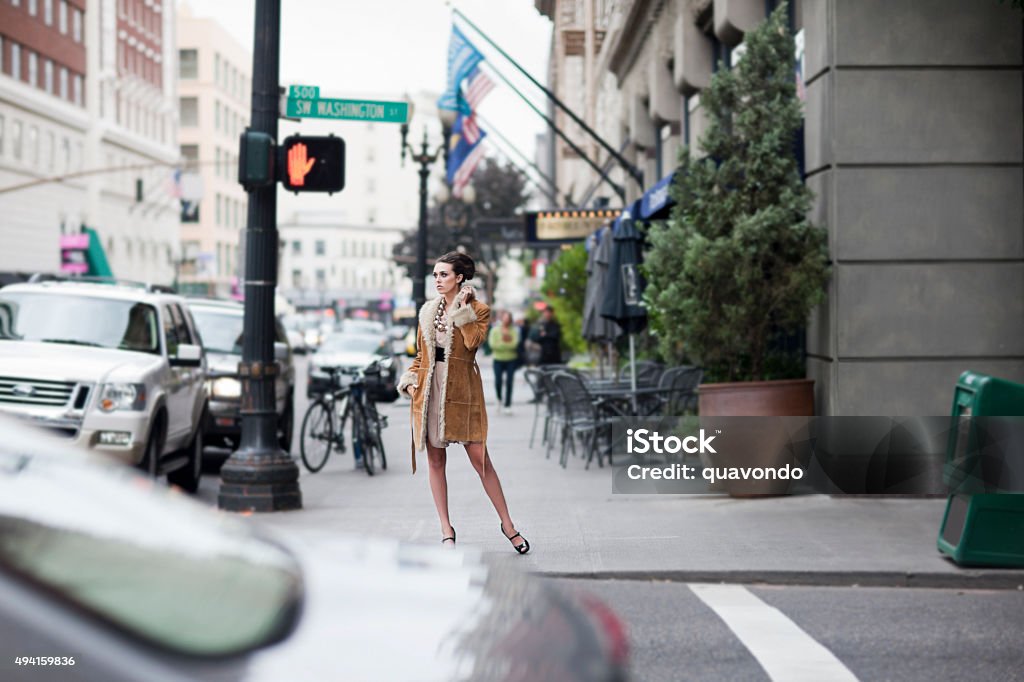 Beautiful Stylish Young Woman Fashion Model on Busy Downtown Street Stylish young woman in coat and heels on busy downtown sidewalk. Copy space. Corner Stock Photo