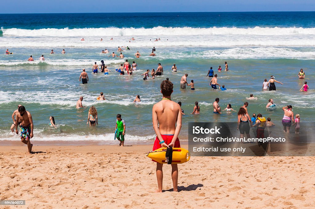 Lifeguard Beach Ocean Public Ramsgate South Coast, South Africa - October 4, 2015: Lifeguard with safety rescue swimming buoy watching public swim in ocean waves Lifeguard Stock Photo