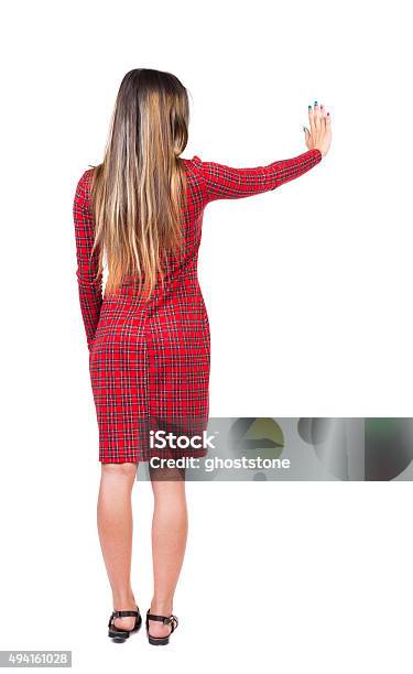 Back View Of Young Woman Presses Down On Something Stock Photo - Download Image Now - Buttocks, Button - Sewing Item, One Woman Only