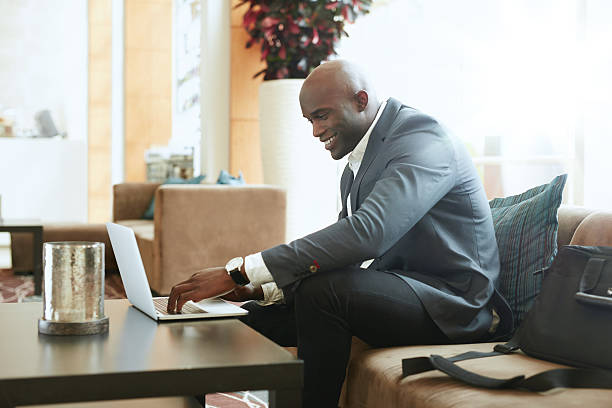 istock Businessman working on laptop in hotel lobby 494164974