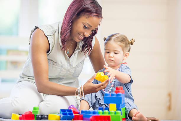 istock Little Girl Grabbing Building Blocks 494165182