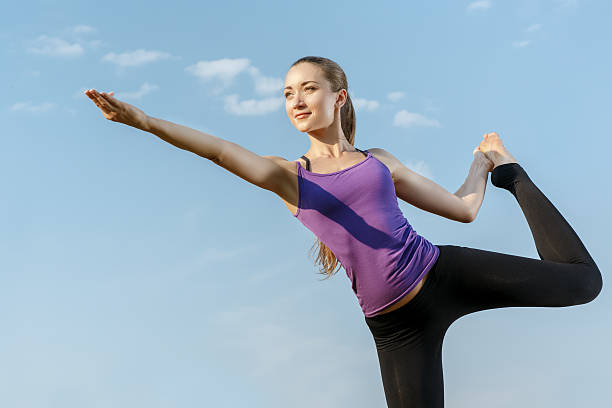 istock Young woman in a balancing yoga position 494165212