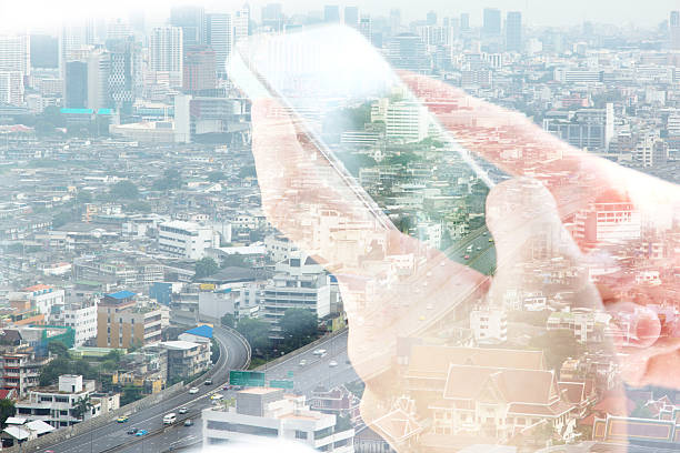 istock smart phone and cityscape background 494165684