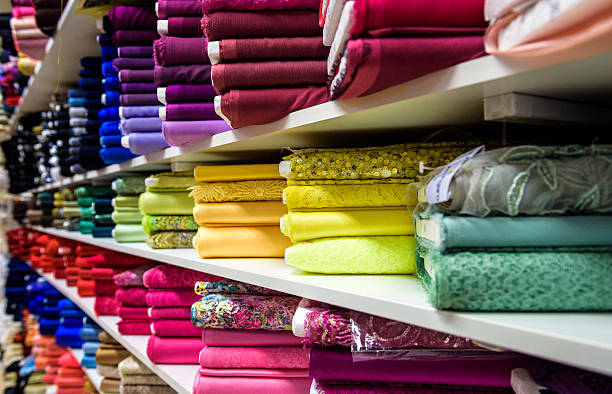rouleaux de tissu et de textiles dans un magasin d'usine de magasin - fashion industry photos et images de collection