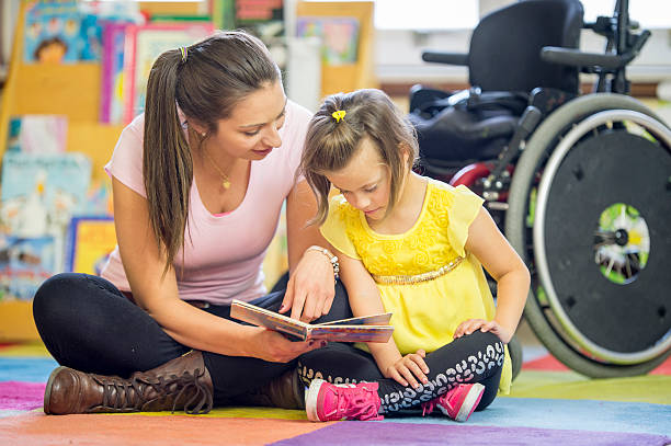 istock Caregiver Reading a Book with a Mentally Disabled Child 494166488