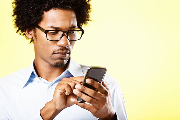 istock Serious afro-haired man busy with his cellphone 494178115