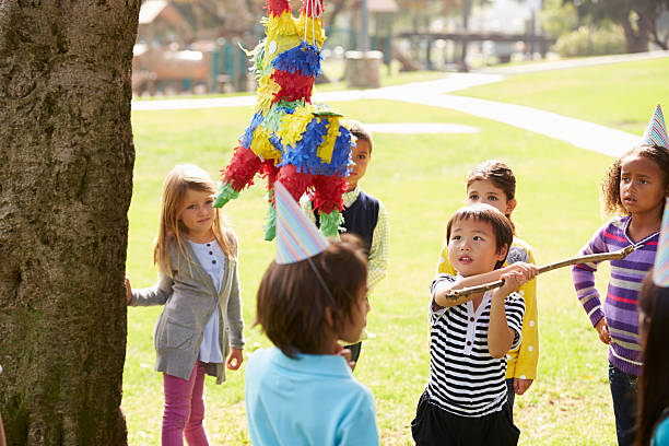 istock Children Hitting Pinata At Birthday Party 494178313