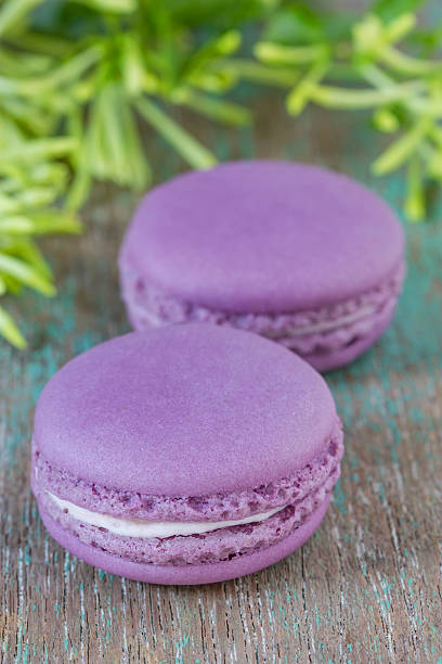 istock Lavender macaroons with cream on a wooden table. 494179653