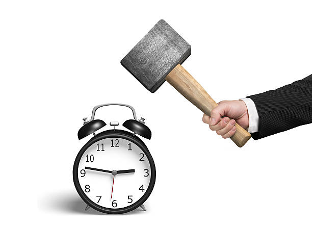 Hitting alarm clock Hitting alarm clock isolated in white background smash alarm clock stock pictures, royalty-free photos & images