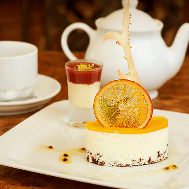 orange cheesecake on a white plate stock photo