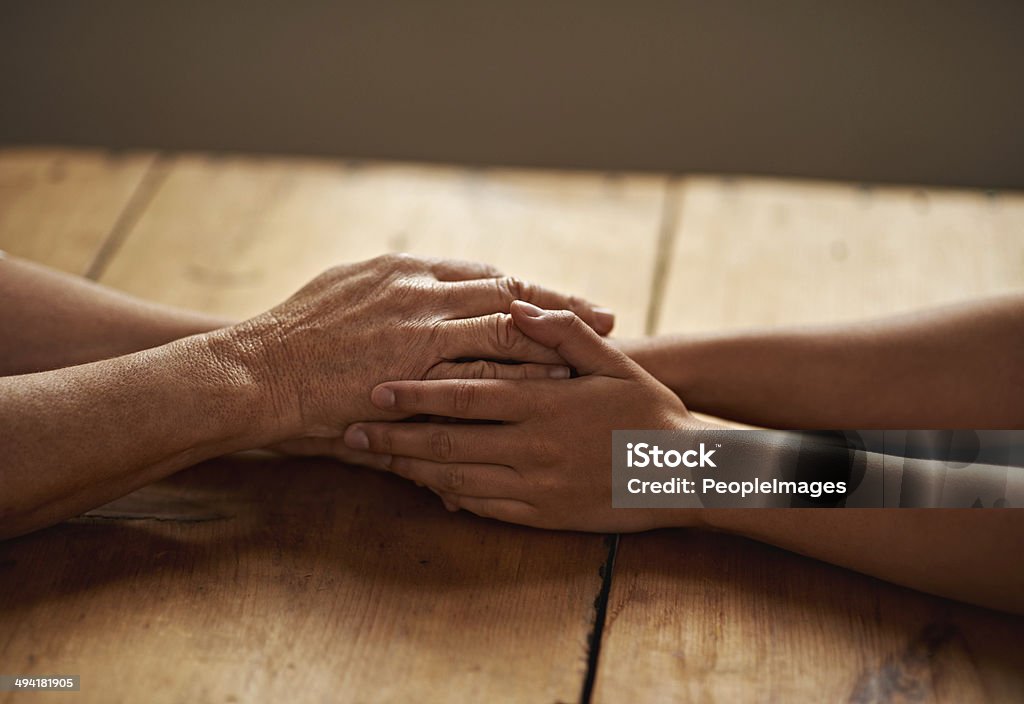 Everything will be alright A cropped shot of a woman holding a loved one's hand in support Holding Hands Stock Photo