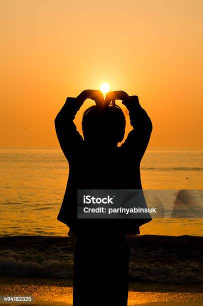 Silhouette Boy Hand Making A Heart Shape Stock Photo - Download Image Now - Back Lit, Beach, Colors