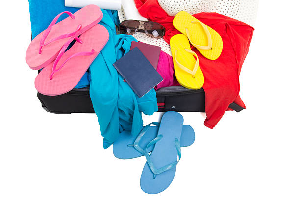 istock open suitcase with clothes and passports 494182342
