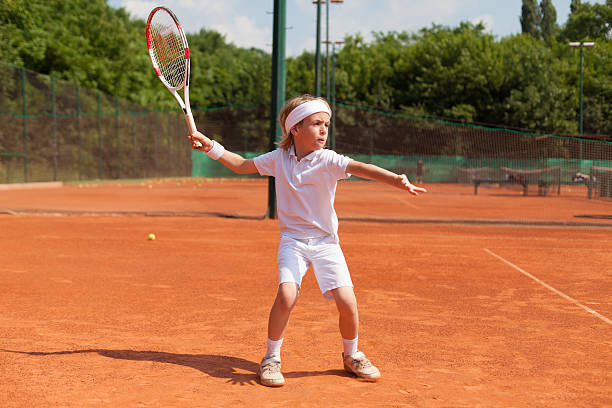 boy training tennis stock photo